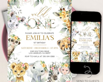 May include: A watercolor-style invitation for a first birthday party with a jungle theme. The invitation features a gold "Wild One" text with a floral wreath and various jungle animals, including a giraffe, lion, elephant, zebra, and monkey. The invitation includes the birthday girl's name, "Emilia's", the date and time of the party, and the address. The invitation also includes a phone number for RSVP.