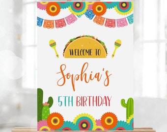 May include: A welcome sign for a 5th birthday party with a colorful fiesta theme. The sign features a taco, maracas, and the text "Welcome to Sophia's 5th Birthday".