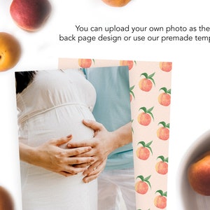 May include: A couple expecting a baby, with the woman in a white dress, holding her belly. The background is a peach pattern with a peach on each peach.