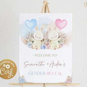 May include: A gender reveal sign with a watercolor background featuring two bunnies holding blue and pink heart balloons. The sign says "Welcome to Samantha + Aiden's Gender Reveal".