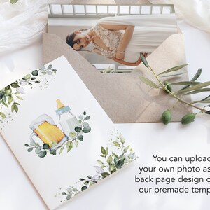 May include: A white card with a watercolor illustration of a beer mug and a baby bottle surrounded by green leaves. The text "You can upload your own photo as the back page design or use our premade template" is printed below the illustration.