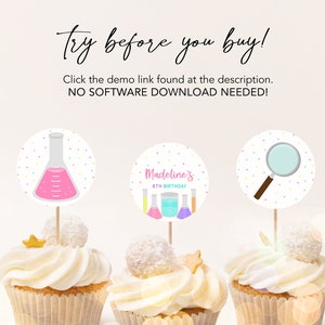 May include: Three cupcakes decorated with colorful science-themed cupcake toppers. The toppers feature a beaker, a magnifying glass, and a set of beakers with the text "Madeline's 8th Birthday".