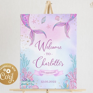 May include: Welcome to Charlotte's 5th Birthday party sign with a mermaid tail, seashells, and a treasure chest. The sign is on a wooden easel.