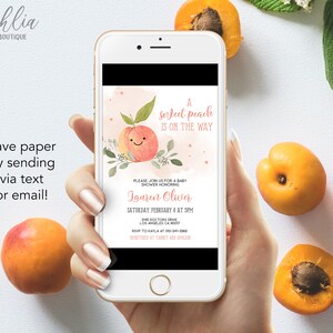 May include: A peach-themed baby shower invitation on a smartphone screen. The invitation features a peach with a smiling face and the text "A sweet peach is on the way". The invitation also includes the name "Lauren Oliver" and the date and time of the shower.
