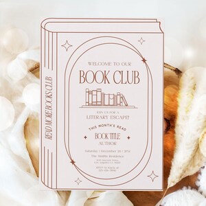 May include: A beige book club invitation with brown text and illustrations. The design features a stylized book outline, stars, and the text "WELCOME TO OUR BOOK CLUB." It includes details for a literary event, with space for the book title and author.
