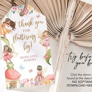 May include: A white thank you tag with a gold glitter font that says "thank you for fluttering by!" with love, Aurora. The tag is decorated with watercolor illustrations of fairies, flowers, mushrooms, and butterflies.