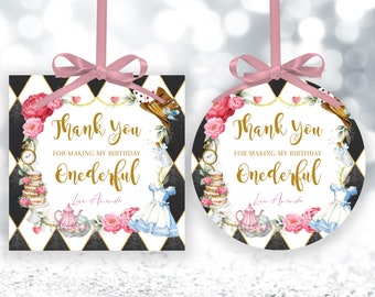 May include: Two Alice in Wonderland themed thank you tags. One is square and the other is round. Both have a black and white checkered background with gold accents. The text reads "Thank you for making my birthday Onederful".