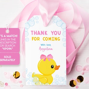 May include: A pink and blue thank you tag with a yellow rubber ducky with a pink bow. The tag says "Thank You For Coming" with the name "Angelina" and the text "It's a match! Links in the description or search "KPO94"  Sold separately."