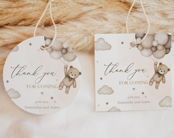 May include: Two baby shower gift tags. One is round, the other square. Both have a teddy bear holding balloons, with the text "Thank you for coming". The tags are light beige with gray clouds and stars. The text "with love, Samantha and Aiden" is also included.