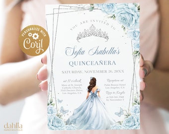 May include: A Quinceañera invitation with a blue and silver design. The invitation features a watercolor illustration of a young woman in a blue dress, a crown, and a floral border. The text on the invitation reads "Sofia Isabella's Quinceañera" and includes the date, time, and location of the event.