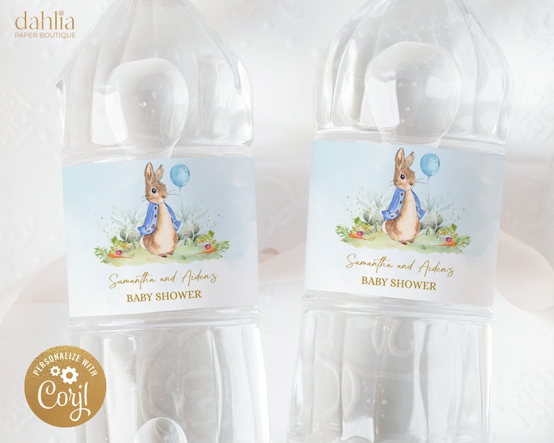 May include: Two clear plastic water bottles with blue and white labels featuring a cartoon rabbit holding a blue balloon. The labels also include the text "Samantha and Aiden's Baby Shower".