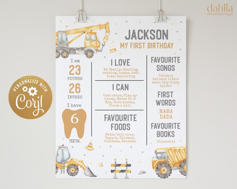 May include: A yellow and grey construction-themed first birthday chart for a boy named Jackson. The chart includes details about his age, weight, height, and favourite things. It features illustrations of construction vehicles and a gold tooth.