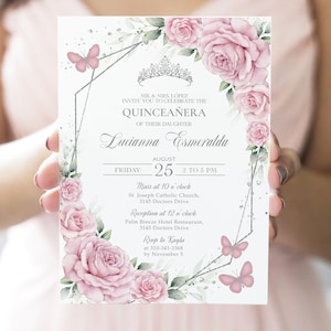 May include: A white invitation card with a silver border and floral design. The text reads "MR. & MRS. LÓPEZ INVITE YOU TO CELEBRATE THE QUINCEAÑERA OF THEIR DAUGHTER Lucianna Esmeralda AUGUST 25 2 TO 5 PM FRIDAY Mass at 10 o'clock St. Joseph Catholic Church, 3145 Doctors Drive Reception at 12 o'clock Palm Breeze Hotel Restaurant, 3145 Doctors Drive Rsup to Kayla at 310-341-3368 by November 5"