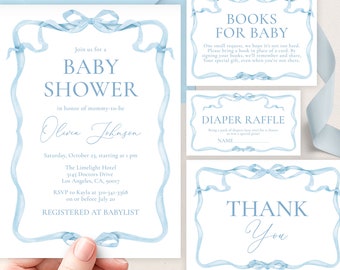 May include: Blue and white baby shower invitation with a watercolor ribbon design. The invitation includes the text "Join us for a Baby Shower in honor of mommy-to-be Olivia Johnson". The invitation also includes the date, time, location, and RSVP information. The invitation also includes a separate card with the text "Books for Baby" and a diaper raffle card.