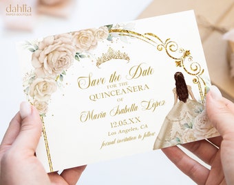 May include: Save the Date invitation for a Quinceañera. The invitation features a gold glitter design with white roses and a crown. The text reads "Save the Date for the Quinceañera of Maria Isabella Lopez 12.05.XX Los Angeles, CA formal invitation to follow."
