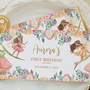 Può includere: Un involucro di barretta di cioccolato bianco con un design floreale e un'illustrazione di fata. Il testo sull'involucro recita "Aurora's First Birthday December 5, 20XX".