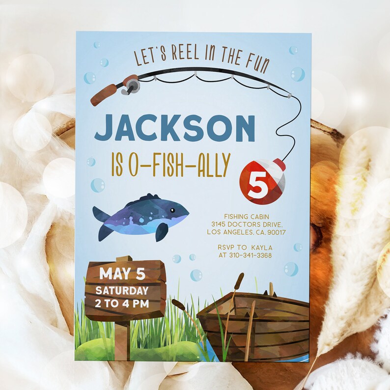 May include: A blue and white fishing-themed birthday invitation for a boy turning five. The invitation features a cartoon fish, a fishing rod, a wooden sign with the text "May 5 Saturday 2 to 4 PM", and a wooden boat. The text "Let's Reel in the Fun" is at the top of the invitation, and the text "Jackson is O-Fish-Ally 5" is in the center.