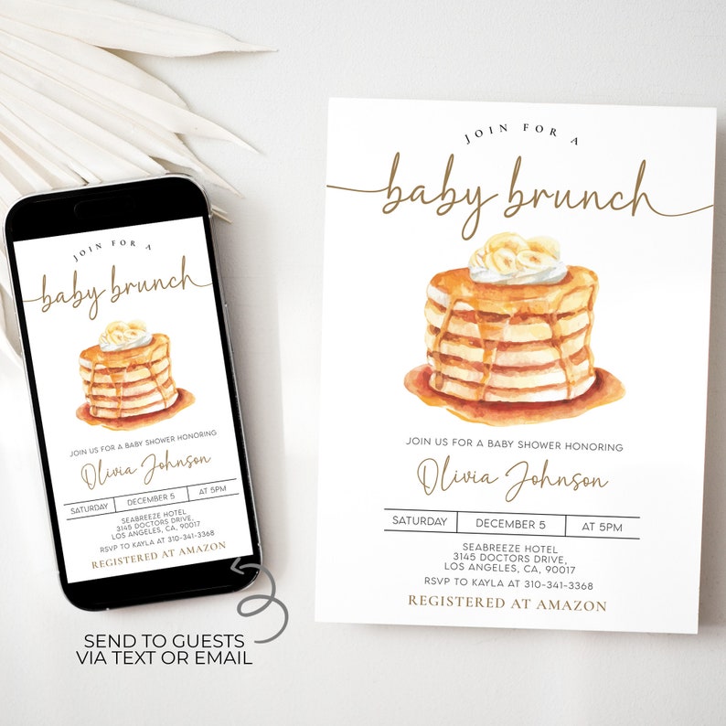May include: A baby shower invitation with a watercolor illustration of a stack of pancakes with banana slices and syrup. The invitation is for a baby brunch and includes the name Olivia Johnson, the date and time of the event, the location, and RSVP information. The text "Registered at Amazon" is also included.