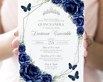 May include: A white invitation with a silver geometric frame and blue floral accents. The text reads "MR. & MRS. LÓPEZ INVITE YOU TO CELEBRATE THE QUINCEAÑERA OF THEIR DAUGHTER Lucianna Esmeralda FRIDAY AUGUST 25 2 TO 5 PM Mass at 10 o'clock St. Joseph Catholic Church, 3145 Doctors Drive Reception at 12 o'clock Palm Breeze Hotel Restaurant, 3145 Doctors Drive Rsvp to Kayla at 310-341-3368 by November 5"