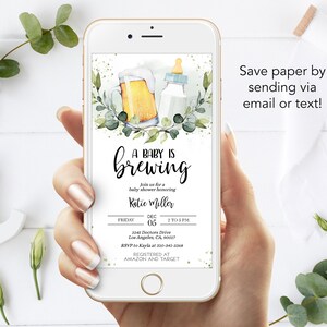 May include: A digital phone screen displaying a baby shower invitation with a watercolor illustration of a beer bottle and a baby bottle. The invitation reads "A Baby is Brewing" and includes the date, time, and location of the event. The text "Save paper by sending via email or text!" is displayed at the bottom of the screen.