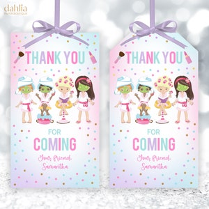 May include: Pink and blue thank you tags with a spa theme. The tags feature a group of cartoon girls wearing spa robes and face masks. The text on the tags reads "Thank You for Coming Your Friend, Samantha".