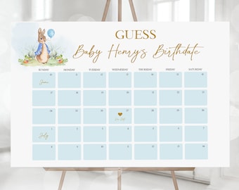 May include: A blue and white calendar with the text "GUESS Baby Henry's Birthdate" at the top. The calendar is set up for June and July with a gold heart marking the 27th of June.
