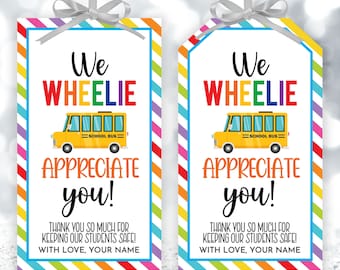 May include: Two printable gift tags with a rainbow striped background. The tags feature a yellow school bus with the text "We Wheelie Appreciate You!" and "Thank you so much for keeping our students safe! With love, your name."
