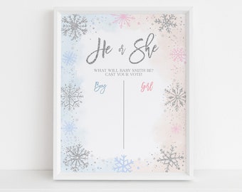 May include: A framed gender reveal sign with a winter theme. The sign features the text "He or She" in silver glitter, with "Boy" and "Girl" options below. Snowflake accents in silver, blue, and pink decorate the edges. The text "WHAT WILL BABY SMITH BE? CAST YOUR VOTE!" is also included.
