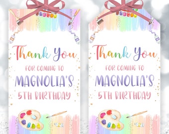 May include: Two colorful thank you tags with a rainbow watercolor background and gold glitter. The tags feature a paint palette and paintbrush with the text "Thank You for coming to Magnolia's 5th Birthday".