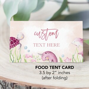 May include: Pink and blue food tent card with a sea turtle, narwhal, and dolphin illustration. The text "custom TEXT HERE" is on the card. The card measures 3.5 by 2 inches when folded.