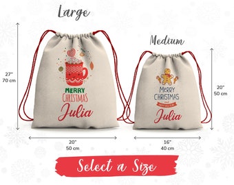 May include: Two drawstring bags with Christmas designs. The larger bag is 70 cm tall and 50 cm wide and features a red mug with marshmallows and the text "Merry Christmas Julia". The smaller bag is 50 cm tall and 40 cm wide and features a gingerbread man and the text "Merry Christmas and Happy New Year Julia".