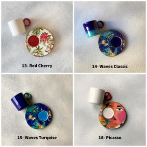 May include: Four sets of coffee cups and saucers with different designs. The designs include red cherry, waves classic, waves turquoise, and Picasso.