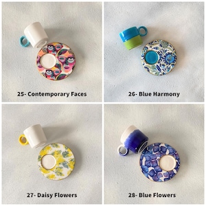 May include: Four sets of espresso cups and saucers with different designs. The first set features a colorful abstract design with faces. The second set has a blue and white floral design. The third set has a yellow and white floral design. The fourth set has a blue and white floral design with a more modern style.