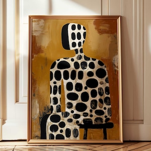 May include: Abstract art print in a gold frame. The artwork features a figure with a black and white pattern of oval shapes against a mustard yellow and brown background. The figure is seated on a small black stool.