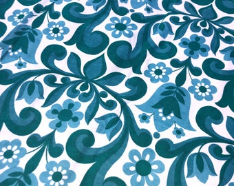 May include: A white fabric with a teal blue floral pattern. The pattern features stylized flowers and leaves.