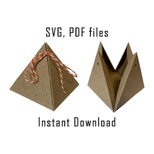 May include: Two brown paper pyramid-shaped boxes, one with a red and white string tied around it. The text "SVG, PDF files" and "Instant Download" is printed below the boxes.