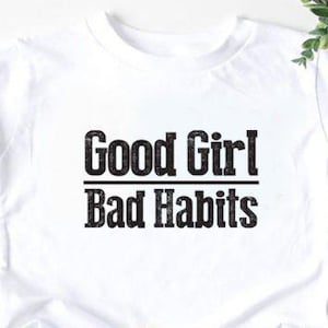 May include: White t-shirt with black text that reads "Good Girl Bad Habits".