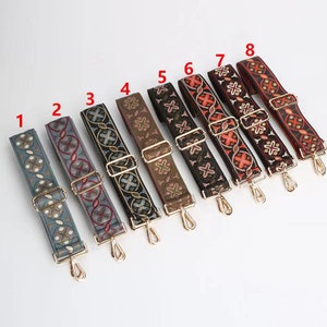 May include: Eight different patterned fabric straps with gold metal clasps. The straps are in various colors, including red, blue, green, and brown. The straps are all the same length and width.