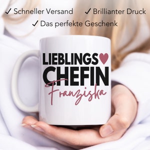 May include: White ceramic mug with a black and pink design. The mug says "Lieblings Chefin Franziska" with a pink heart.