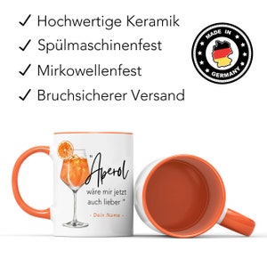 K&ouml;nnte beinhalten: Orangefarbener und wei&szlig;er Keramikbecher mit einer Illustration eines Aperol Spritz Cocktails. Der Becher hat einen orangenen Rand und Griff. Der Text auf dem Becher lautet "Aperol" und "w&auml;re mir jetzt auch lieber" mit Platz f&uuml;r einen Namen.