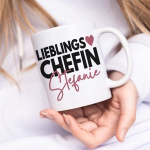 May include: White ceramic mug with black text that reads "Lieblings Chefin Stefanie" with a pink heart.