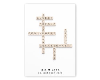May include: A white card with a crossword puzzle made of letter tiles. The words in the puzzle are "Glück", "Erfolg", "Gesundheit", "Freude", and "Gelassenheit". The card also has the text "Iris ♥ Jörg" and "08. Oktober 2023".