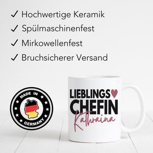 May include: White ceramic mug with a black and pink design. The mug says "Lieblings Chefin Kathrina" with a heart symbol. The mug is made in Germany and is dishwasher and microwave safe.