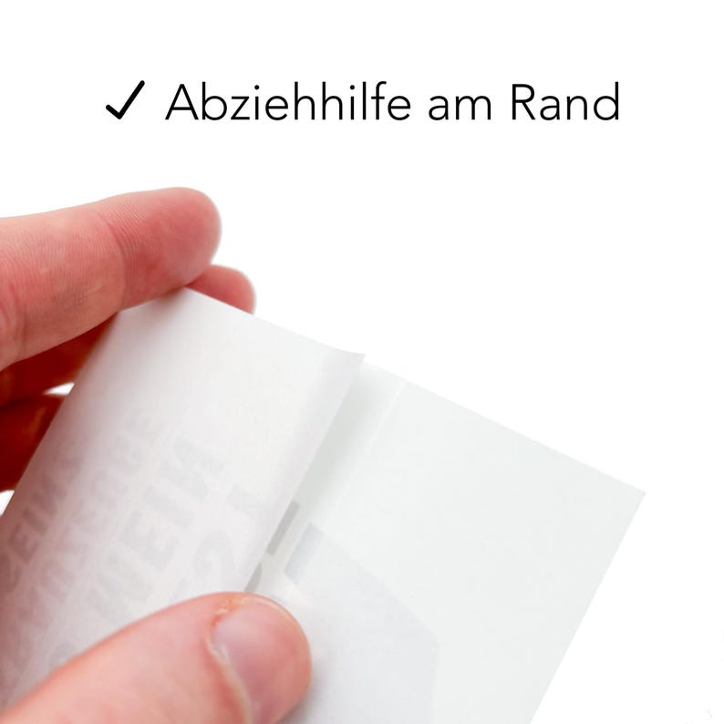 May include: A white sticker sheet with a peel-away backing. The sticker sheet has the text "Abziehhilfe am Rand" printed on it.