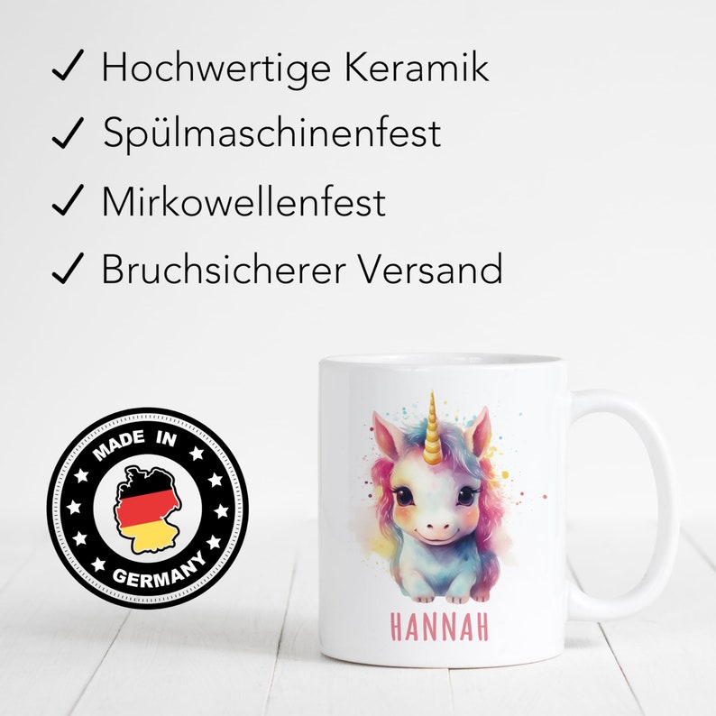 May include: White ceramic mug featuring a colourful unicorn illustration and the name "HANNAH" printed on the base. The mug has a black and white sticker with the words "MADE IN GERMANY" and a map of Germany.