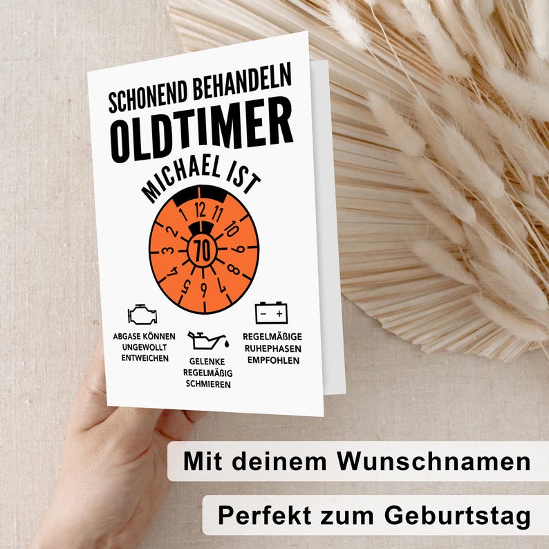 May include: A white card with black and orange text that reads "Schonend Behandeln Oldtimer Michael Ist". The card features a speedometer with a red needle pointing to 70. There are three icons below the speedometer with text that reads "Abgase Konnen Ungewollt Entweichen", "Gelenke Regelmaesig Schmieren", and "Regelmaessige Ruhephasen Empfohlen". The card also has the text "Mit deinem Wunschnamen Perfekt zum Geburtstag".