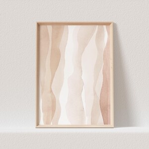 May include: Abstract art print featuring a watercolour design of wavy lines in shades of beige and brown. The print is framed in a light wood frame.