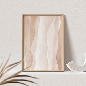 May include: A framed abstract print with a watercolour design of wavy lines in shades of brown and beige.