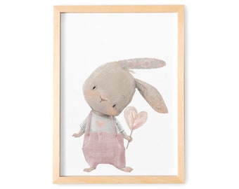 May include: A framed illustration of a cute bunny rabbit wearing pink overalls and holding a pink heart-shaped lollipop. The bunny has a light brown body and a light gray face with pink cheeks.