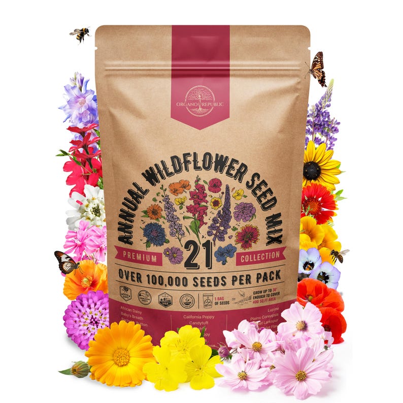 May include: A brown bag of annual wildflower seed mix with the text "Annual Wildflower Seed Mix" and "Over 100,000 Seeds Per Pack". The bag is surrounded by colorful flowers, bees, and butterflies.
